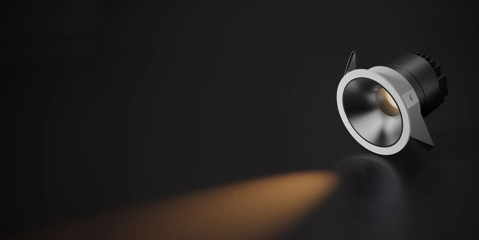 A Staron spotlight on a dark background, casting a warm beam of light